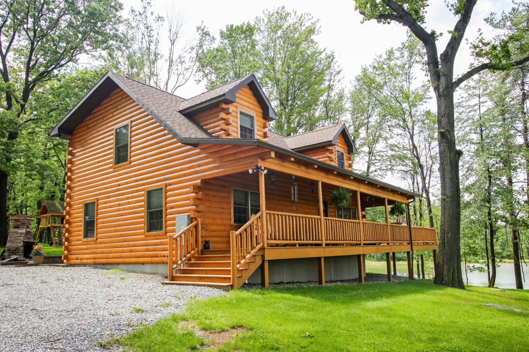 Shade Mountain II log cabin front exterior with wraparound porch